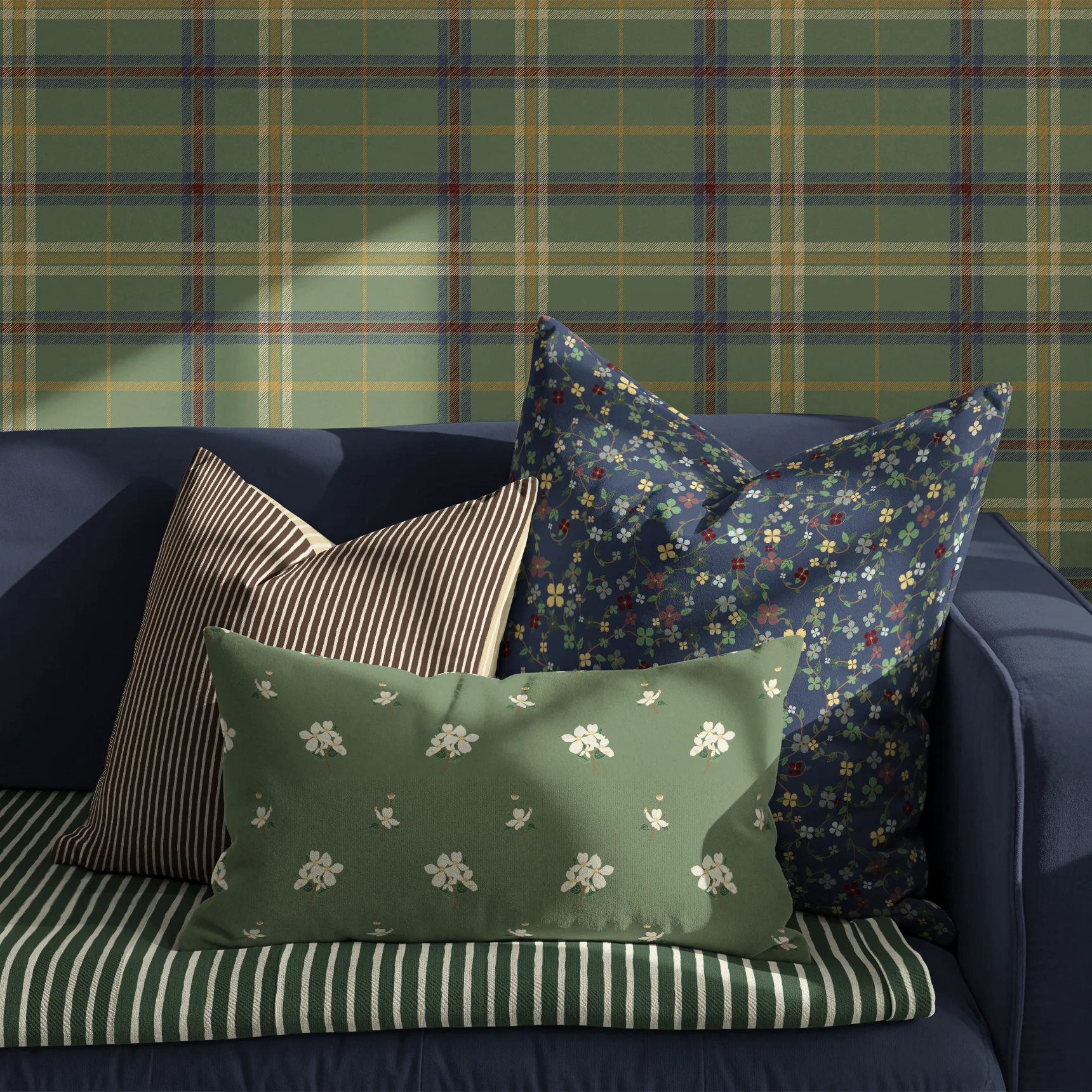 Couch and Pillows in front of wallpapered wall pattern drenched in "Under the Dogwood Tree" collection.